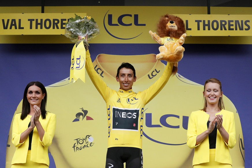 epa07744680 Colombia&#039;s Egan Bernal (C) of Team Ineos celebrates on the podium after retaining the overall leader&#039;s yellow jersey following the 20th stage of the 106th edition of the Tour de  ...