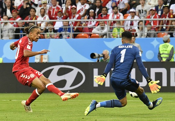 Denmark&#039;s Yussuf Yurary Poulsen, left, kicks the ball to score during the group C match between Peru and Denmark at the 2018 soccer World Cup in the Mordovia Arena in Saransk, Russia, Saturday, J ...