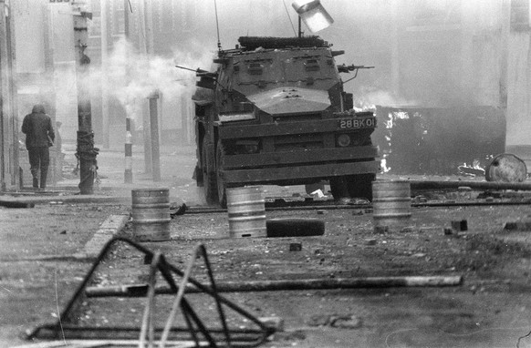 FILE - In this April 17, 1972 file photo, a British Army armoured vehicle makes its way along a barricade while on patrol in the Lower Falls area of west Belfast. Trouble in the area erupted after the ...