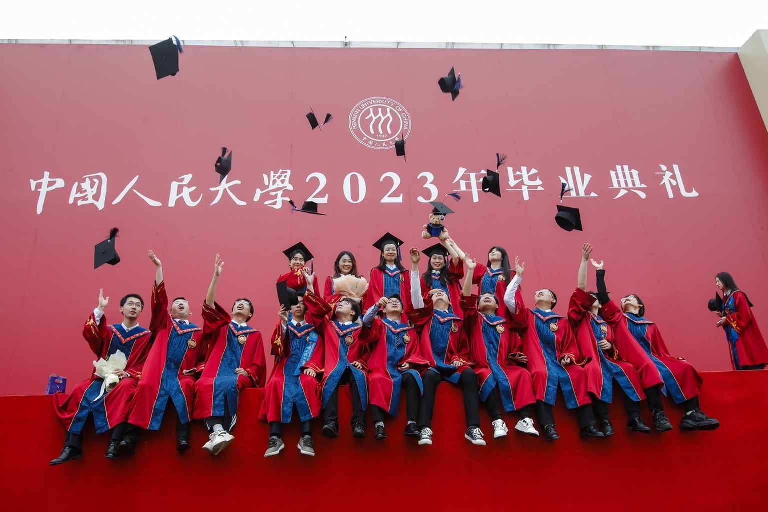 epa10711897 Bachelor's and master's graduates are photographed in a group photo after their graduation ceremony at Renmin University in Beijing, China on June 26, 2023.  Rising to 11.6 million...