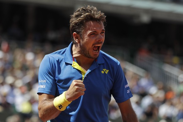 Switzerland's Stan Wawrinka clenches his fist after scoring a point against Britain's Andy Murray during their semifinal match of the French Open tennis tournament at the Roland Garros stadium, in Par ...