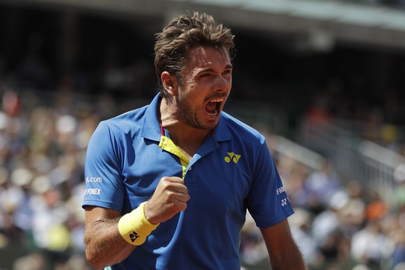 Switzerland&#039;s Stan Wawrinka clenches his fist after scoring a point against Britain&#039;s Andy Murray during their semifinal match of the French Open tennis tournament at the Roland Garros stadi ...