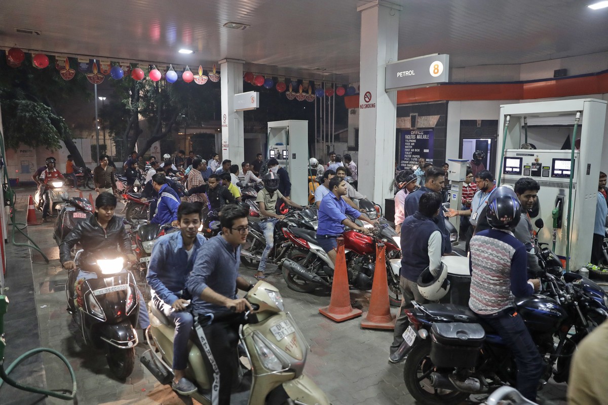 Indians crowd a gas station, one of the few places still accepting the high denomination 1000 and 500 currency notes, in New Delhi, India, Tuesday, Nov. 8, 2016. India's highest-denomination curr ...