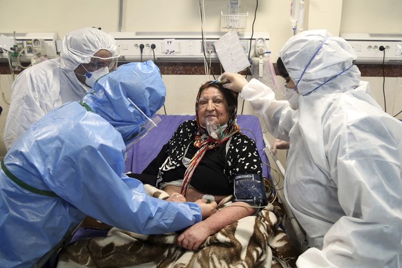 FILEâ?? In this Sunday, March 8, 2020 file photo, medics treat a patient infected with the new coronavirus, at a hospital in Tehran, Iran. Nine out of 10 cases of the virus in the Middle East come fro ...