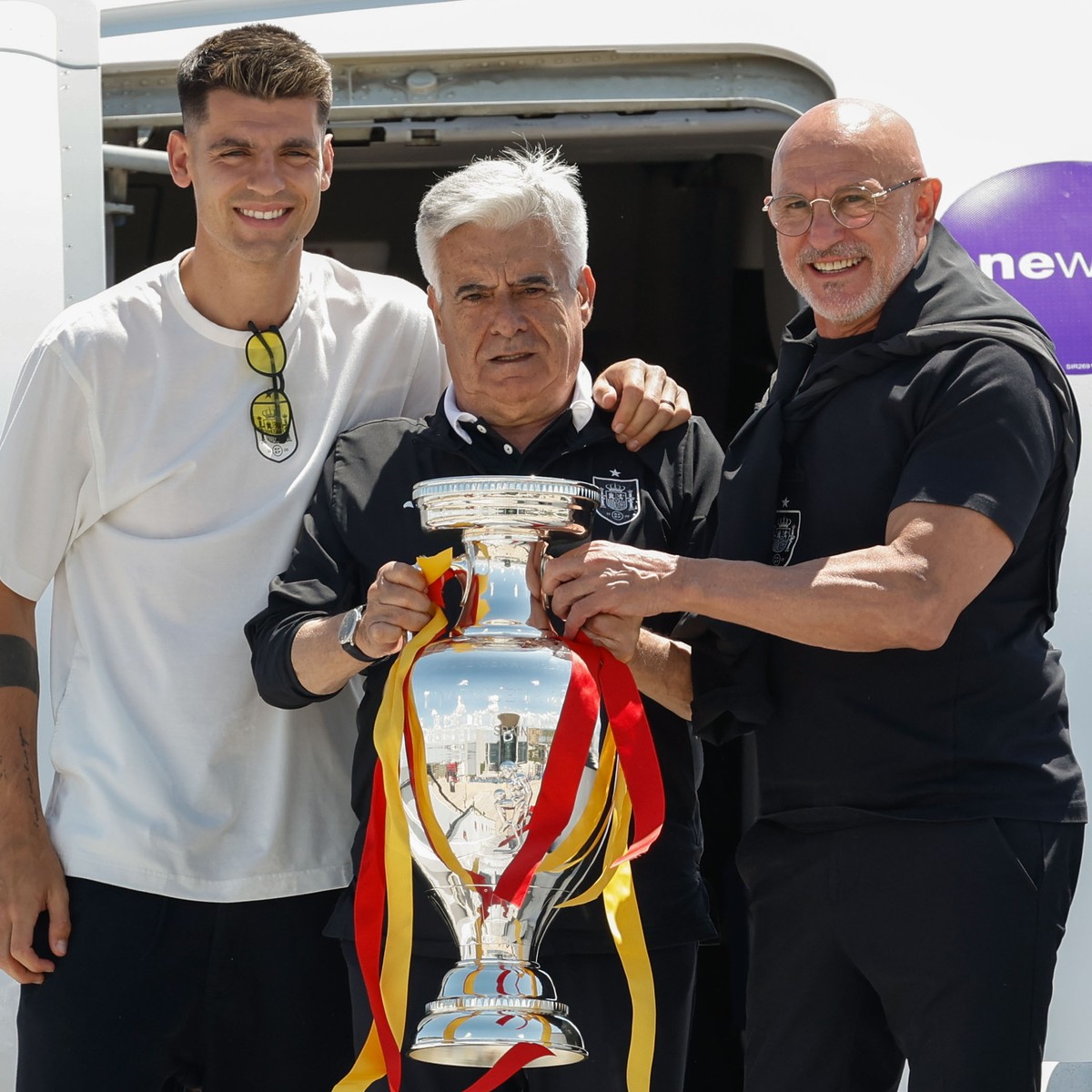 epa11479942 Spanish Football Association (RFEF) President Pedro Rocha (C) holds the trophy next to Spain's head coach Luis de la Fuente (R) and Spain's captain Alvaro Morata (3-L) upon their ...