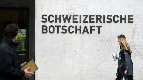 epa05943501 People walk past the entrance of the Swiss Embassy, in Berlin, Germany, 04 May 2017. The German Government called in the Swiss ambassador for a meeting after the detention of suspected spy ...