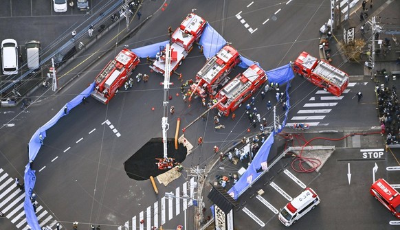 Sinkhole at intersection near Tokyo Photo taken from a Kyodo News helicopter on Jan. 28, 2025, shows rescue operations underway at a large sinkhole that swallowed a truck at an intersection in Yashio, ...