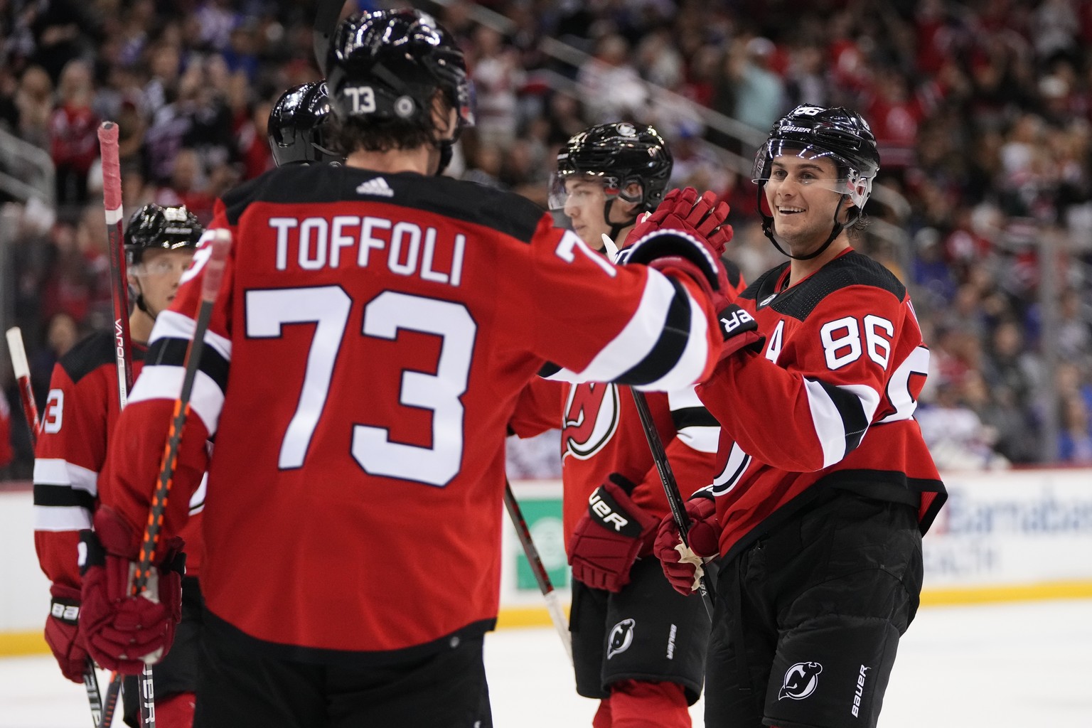 New Jersey Devils&#039; Jack Hughes (86) smiles as he celebrates with Tyler Toffoli (73) after scoring a goal against the New York Rangers during the second period of an NHL preseason hockey game Wedn ...