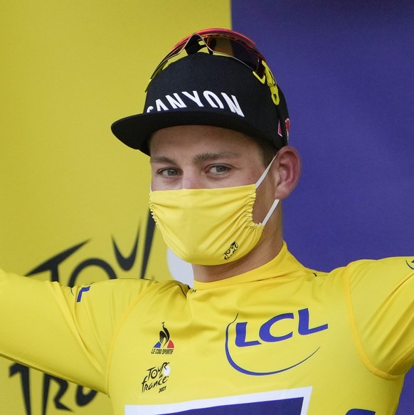 Netherland&#039;s Mathieu Van Der Poel, wearing the overall leader&#039;s yellow jersey, celebrates on the podium of the third stage of the Tour de France cycling race over 182.9 kilometers (113.65 mi ...