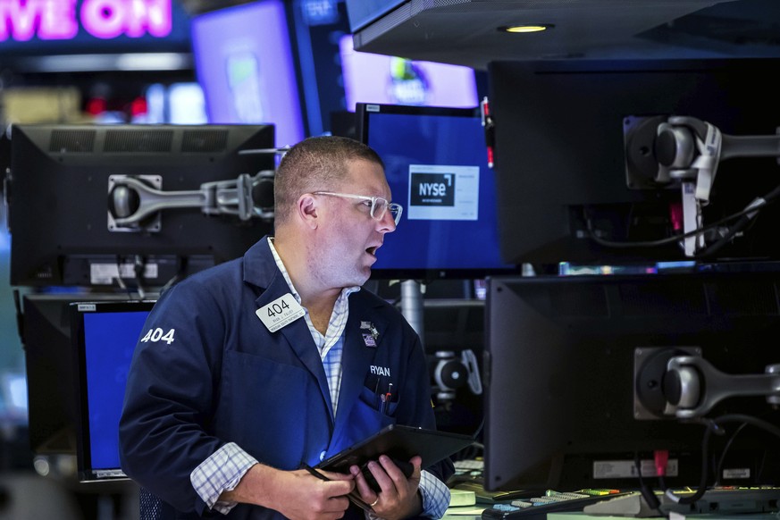 In this photo provided by the New York Stock Exchange, trader Ryan Falvey works on the floor, Tuesday, May 17, 2022. Stocks rose in afternoon trading on Wall Street Tuesday as investors review an enco ...