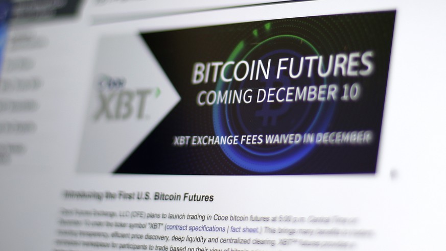 This Friday, Dec. 8, 2017, photo shows the Chicago Board Options Exchange website announcing that bitcoin futures will start trading on the CBOE on Sunday evening, Dec. 10. Bitcoin futures will start  ...