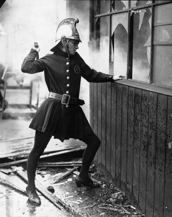 Woman Firefighter from the Achille Serre Ladies Fire Brigade during a drill, London, England, 1926.