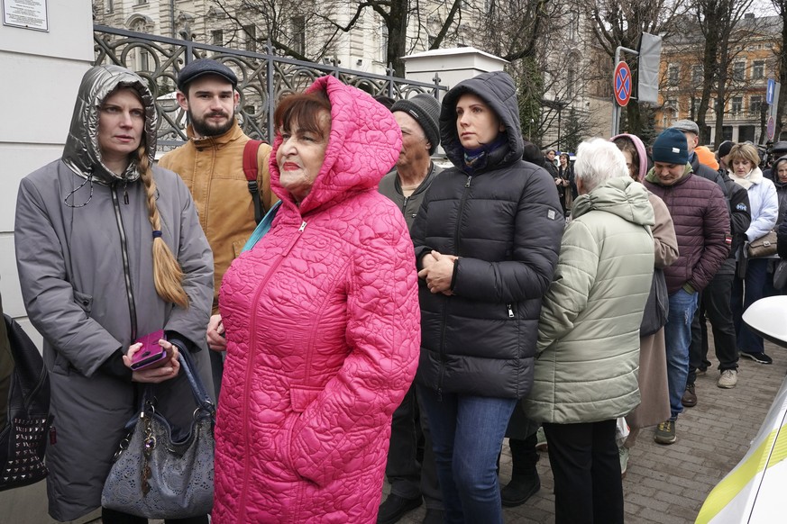 People queue to vote outside the Russian Embassy in Riga, Latvia, Sunday, March 17, 2024. Russians at home and abroad are heading to the polls for a presidential election that is all but certain to ex ...
