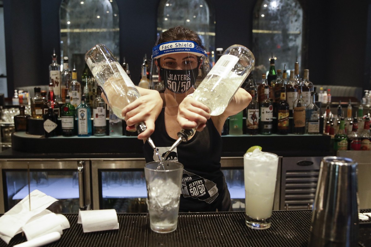 A bartender mixes a drink while wearing a mask and face shield at Slater's 50/50 Wednesday, July 1, 2020, in Santa Clarita, Calif. California Gov. Gavin Newsom has ordered a three-week closure of ...