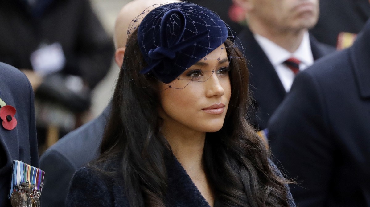 FILE - In this Thursday, Nov. 7, 2019 file photo Meghan the Duchess of Sussex stands after she and her husband Britain's Prince Harry placed a Cross of Remembrance as they attend the official ope ...