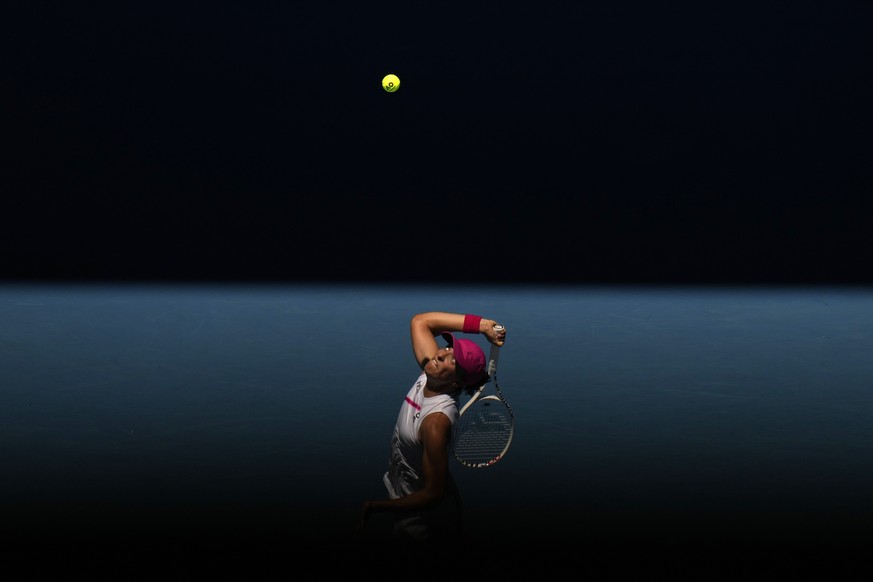 Iga Swiatek of Poland serves to Sofia Kenin of the U.S. during their first round match at the Australian Open tennis championships at Melbourne Park, Melbourne, Australia, Tuesday, Jan. 16, 2024. (AP  ...