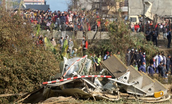 epa10406664 The wreckage at the crash site of a Yeti Airlines ATR72 aircraft in Pokhara, central Nepal, 15 January 2023. A Yeti Airlines ATR72 aircraft carrying 72 people on board, 68 passengers and 4 ...