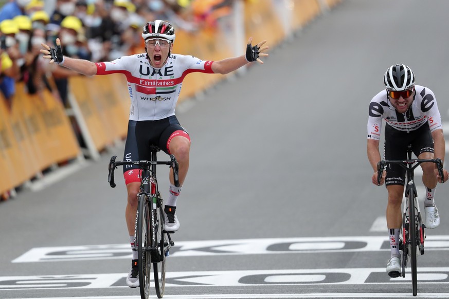 Slovenia&#039;s Tadej Pogacar crosses the finish line ahead of third placed Switzerland&#039;s Marc Hirschi, right, to win the ninth stage of the Tour de France cycling race over 153 kilometers (95 mi ...