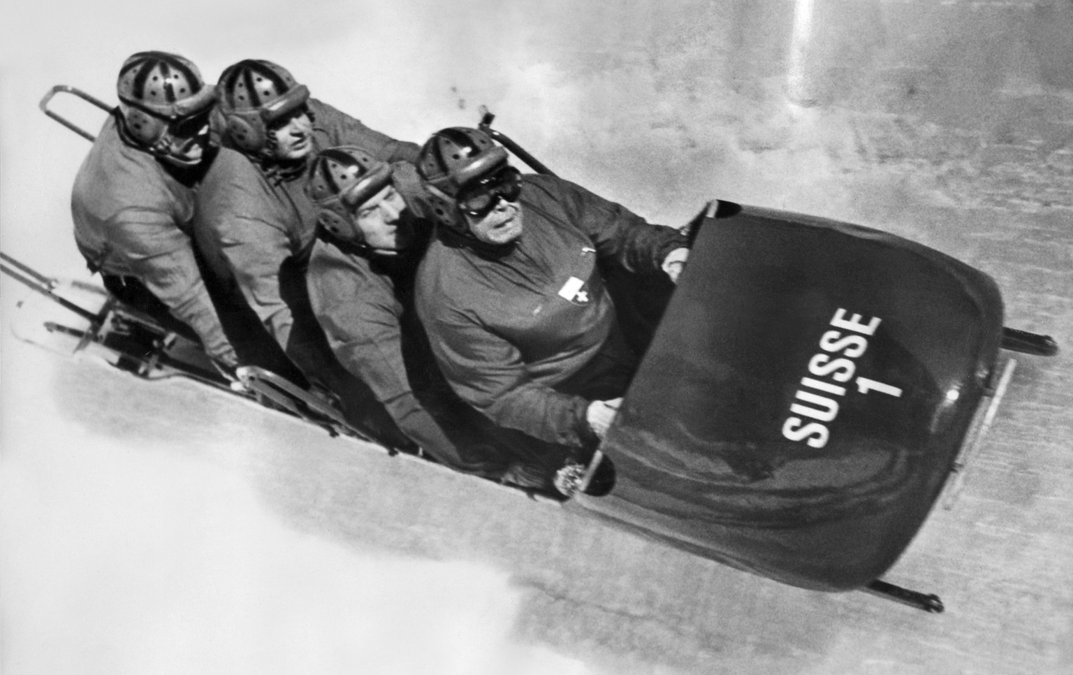 The Swiss Bobsleigh Team I with pilot Franz Kapus and his backmen Robert Alt, Gottfried Diener and Heinrich Angst, from front to back, on the way to their gold medal in the four-man bob, taken at the  ...