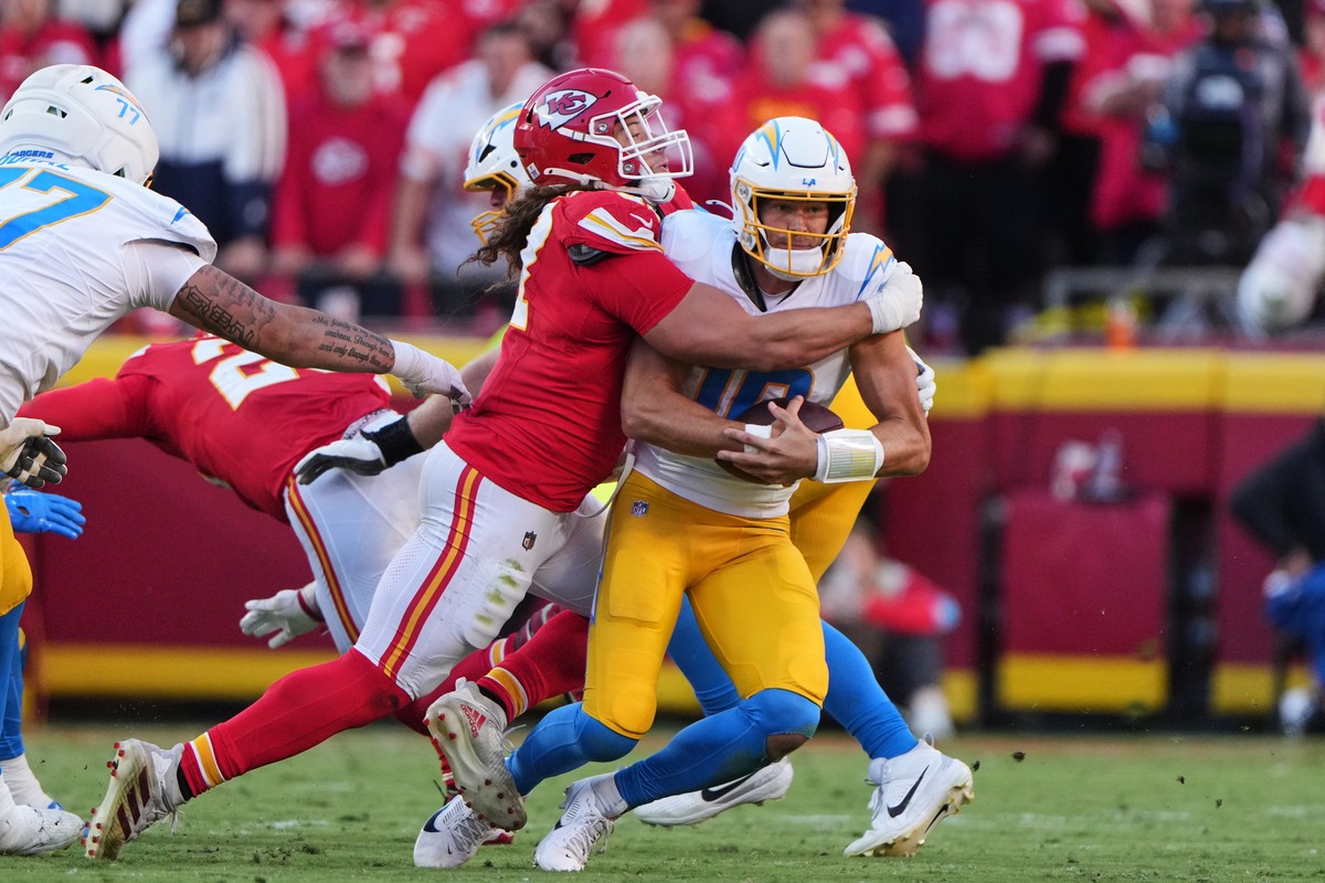 Los Angeles Chargers quarterback Justin Herbert (10) is sacked by Kansas City Chiefs defensive end Ashton Gillotte during the second half of an NFL football game in Kansas City, Mo., Sunday, Oct. 18,  ...