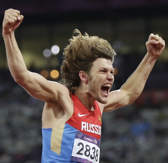 Russia's Ivan Ukhov celebrates winning gold in the men's high jump final during the athletics in the Olympic Stadium at the 2012 Summer Olympics, London, Tuesday, Aug. 7, 2012. (AP Photo/David J. Phil ...