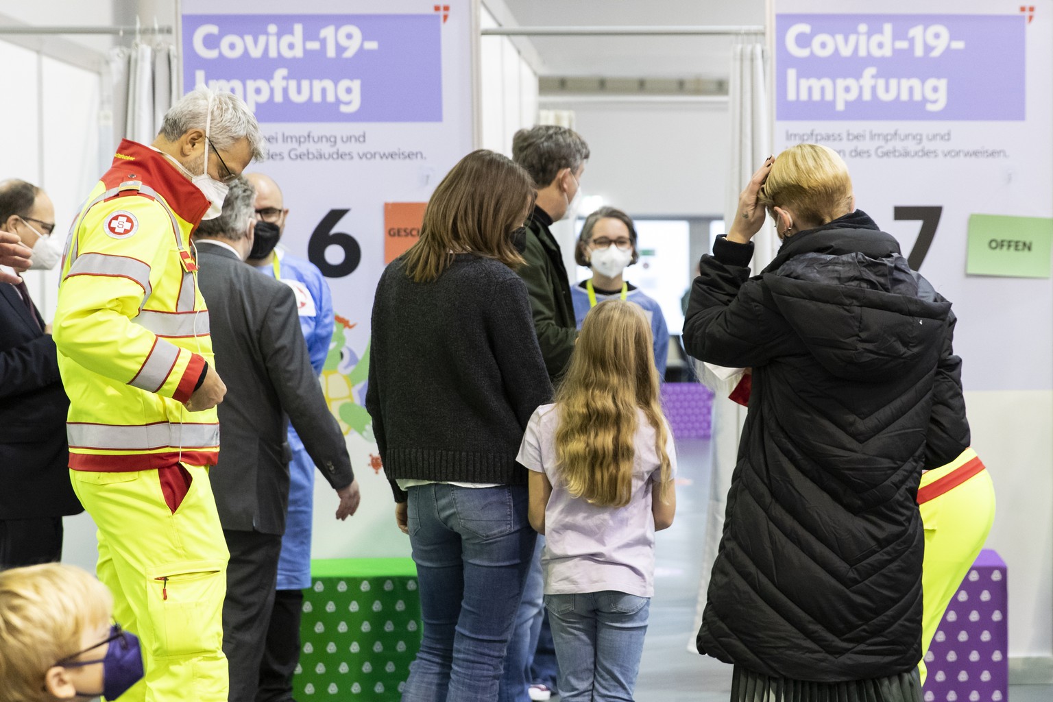 Children wait with their parents to receive the Pfizer vaccine against the COVID-19 disease. The official vaccination for children between the age of 5 and 12 years start today in Vienna, Austria, Mon ...