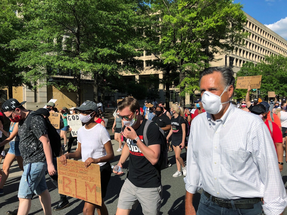 Sen. Mitt Romney, R-Utah, marches with a crowd singing "Little Light of Mine" in Washington on Sunday, June 7, 2020. Romney marched Sunday in the protest against police mistreatment of minor ...