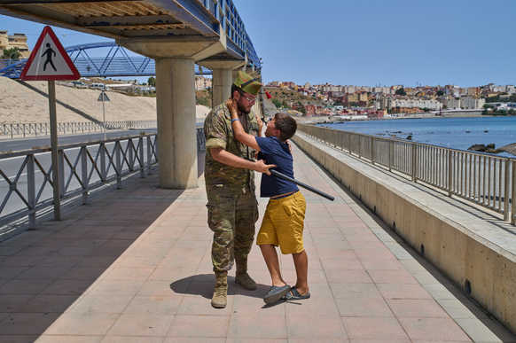 A 12-year-old unaccompanied minor who crossed into Spain is escorted by a Spanish soldier to the Spain-Morocco border as the child begs not to be sent back to Morocco from the Spanish enclave of Ceuta ...