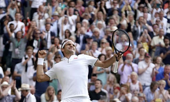 epa07713078 Roger Federer of Switzerland celebrates winning against Rafael Nadal of Spain during their semi final match for the Wimbledon Championships at the All England Lawn Tennis Club, in London,  ...