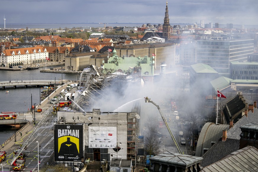 Firefighters work on the building after a fire broke out at the Stock Exchange in Copenhagen, Tuesday, April 16, 2024. The fire was reported Tuesday morning in the historic building, which was undergo ...