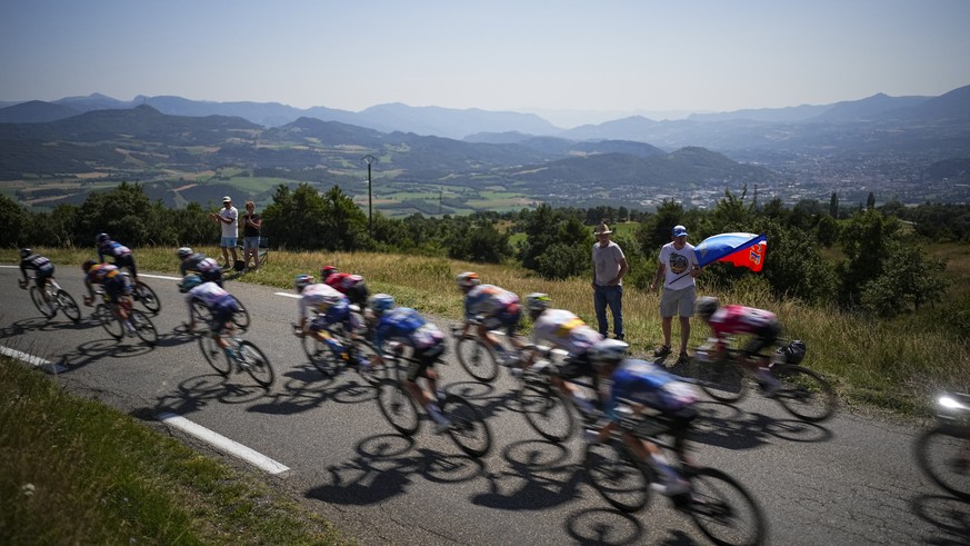 The breakaway group speeds downhill during the eighteenth stage of the Tour de France cycling race over 179.5 kilometers (111.5 miles) with start in Gap and finish in Barcelonette, France, Thursday, J ...
