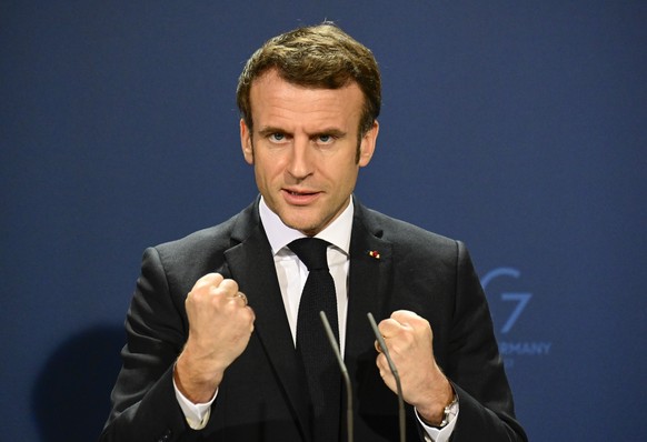 French President Emmanuel Macron gestures as he speaks during a media conference with German Chancellor Olaf Scholz head of their meeting at the chancellery in Berlin, Germany, Tuesday, Jan. 25, 2022. ...