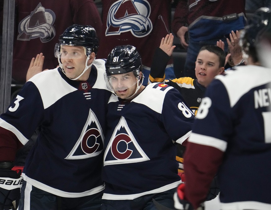 Colorado Avalanche defenseman Jack Johnson, left, congratulates center Denis Malgin after he scored a goal against the Arizona Coyotes in the first period of an NHL hockey game, Saturday, March 11, 20 ...