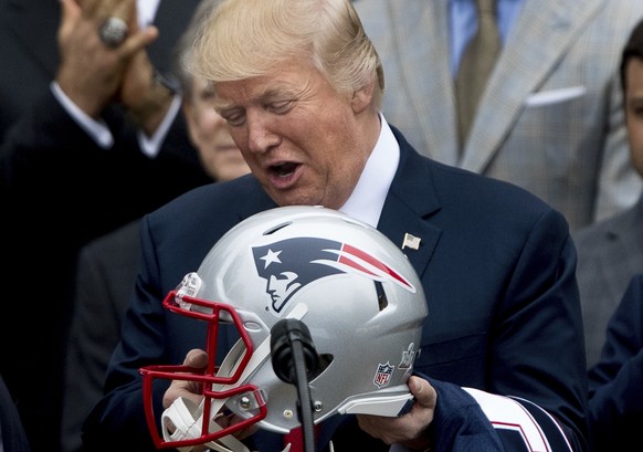 President Donald Trump is presented with a New England Patriots football helmet by Patriots head coach Bill Belichick and New England Patriots owner Robert Kraft during a ceremony on the South Lawn of ...