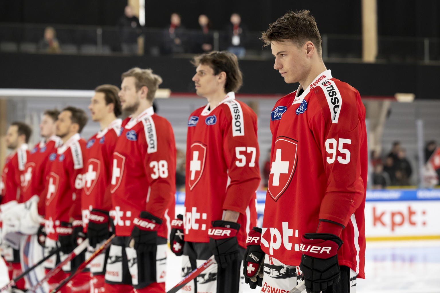 Switzerland&#039;s Tyler Moy, right, and his teammates react during the National anthem before the Ice Hockey World Cup preparation match between Switzerland and Slovakia, Saturday, 15. April 2023, in ...