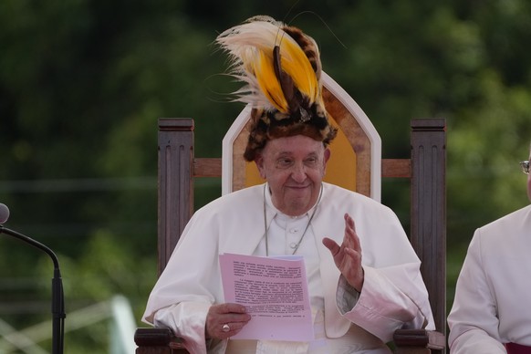 Pope Francis wears a traditional hat during a meeting with faithful in Vanimo, Papua New Guinea, Sunday, Sept. 8, 2024. Despite the considerable security concerns of entering a region torn by tribal r ...