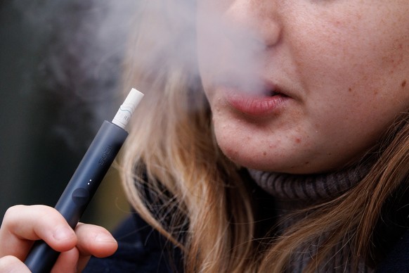 epa11244991 A young person uses a vaping product in London, Britain, 26 March 2024. Tadeu Marroco, chief executive of British American Tobacco (BAT), claims the UK government&#039;s Tobacco and Vapes  ...