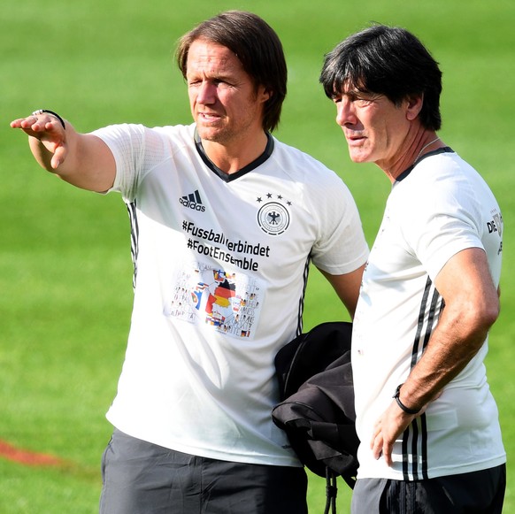 epa05350569 German national soccer team head coach Joachim Loew (R) and assistant coach Thomas Schneider (L) lead their team&#039;s training session at the team hotel in Evian-les-Bains, France, 07 Ju ...