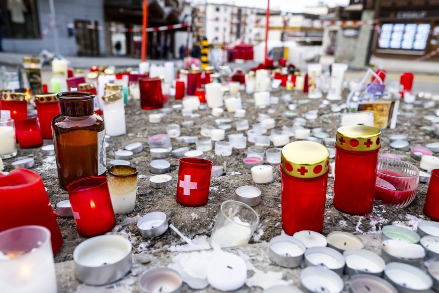 epa12621397 Candles are placed near the area where an unidentified origin fire broke out at the 'Le Constellation' bar and lounge leaving people dead and injured, during New Year's cele ...