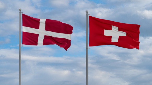 Switzerland and Denmark flags waving together in the wind on blue cloudy sky, two country relationship concept Model Released Property Released xkwx Denmark flag sky nation waving wind resilience spir ...