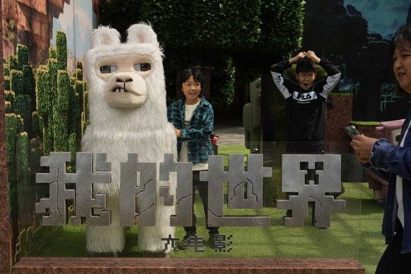 Children react to a promotion for the &quot;A Minecraft Movie&quot; in Beijing, China, Friday, April 4, 2025. (AP Photo/Ng Han Guan)
China Daily Life