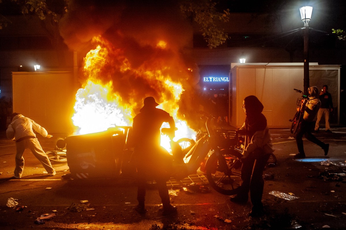 October 24, 2026, Barcelona, Spain: Demonstrators feed a burning barricade amid unrest in downtown Barcelona. Clashes between demonstrators and police, looting and widespread vandalism were reported a ...