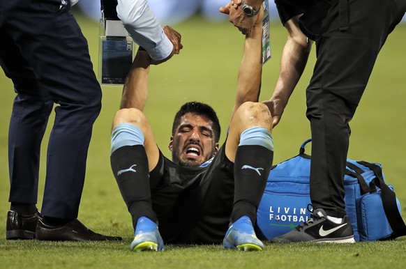 Uruguay&#039;s Luis Suarez is helped after a foul during the round of 16 match between Uruguay and Portugal at the 2018 soccer World Cup at the Fisht Stadium in Sochi, Russia, Saturday, June 30, 2018. ...