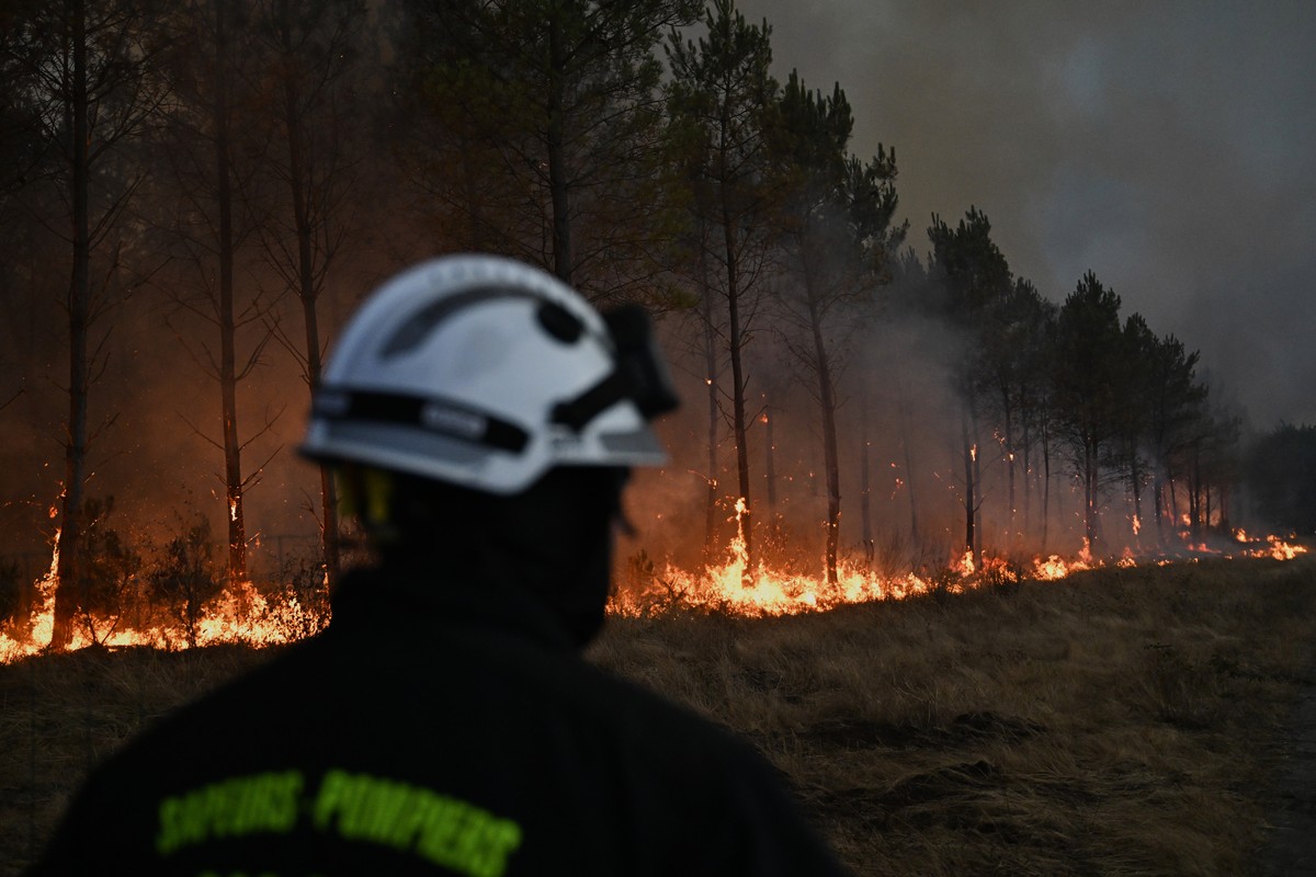 FILE - A firefighter walks in front of burning trees as a wildfire rages near Marcheprime, outside, Bordeaux, France, July 26, 2026. (AP Photo/Emma Da Silva, File)
Climate Europe Wildfires Worsening