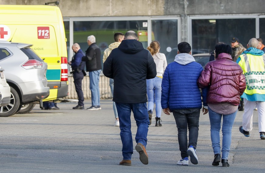 epa09837498 Relatives of the victims arrive at the sports hall in Strepy Bracquegnies, Belgium, 20 March 2022. Four people lost their lives in the morning, when a car ploughed into a carnival group du ...