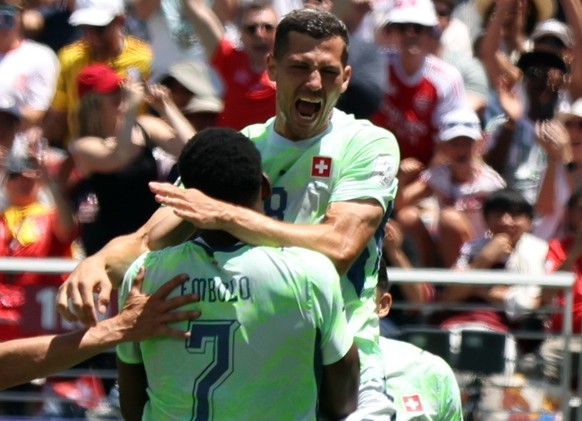 epa13035140 Breel Embolo of Switzerland (C) celebrates with Remo Freuler of Switzerland (up) after scoring the 1-0 by penalty during the FIFA World Cup 2026 group stage match Qatar against Switzerland ...