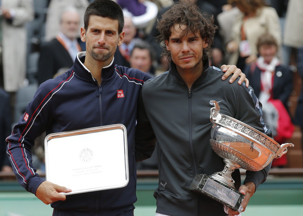 Spain's Rafael Nadal, right, and Serbia's Novak Djokovic hold their trophy after their men's final match in the French Open tennis tournament at the Roland Garros stadium in Paris, Mond ...
