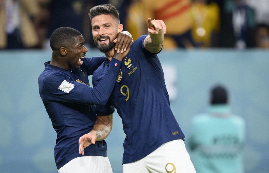 epa10321347 Olivier Giroud of France celebrates with teammate Ousmane Dembele (L) after scoring the second of his team during the FIFA World Cup 2022 group D soccer match between France and Australia  ...