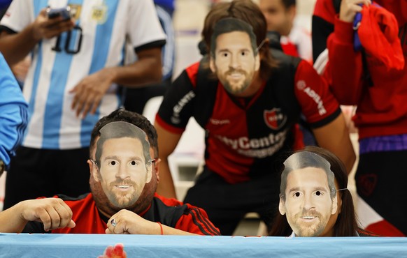 epa10371899 Fans of Argentina wear masks depicting Lionel Messi prior to the FIFA World Cup 2022 Final between Argentina and France at Lusail stadium in Lusail, Qatar, 18 December 2022. EPA/Ronald Wit ...