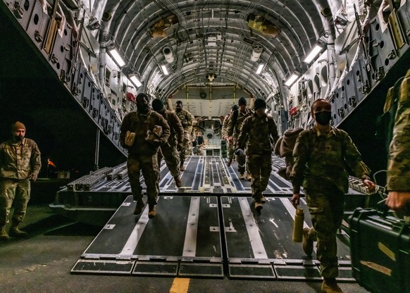 epa09729697 A handout photo made available by the US Army shows the arrival of 18th Airborne Corps Soldiers in Wiesbaden, Germany, 04 February 2022 (issued 05 February 2022). These are the first of 2, ...